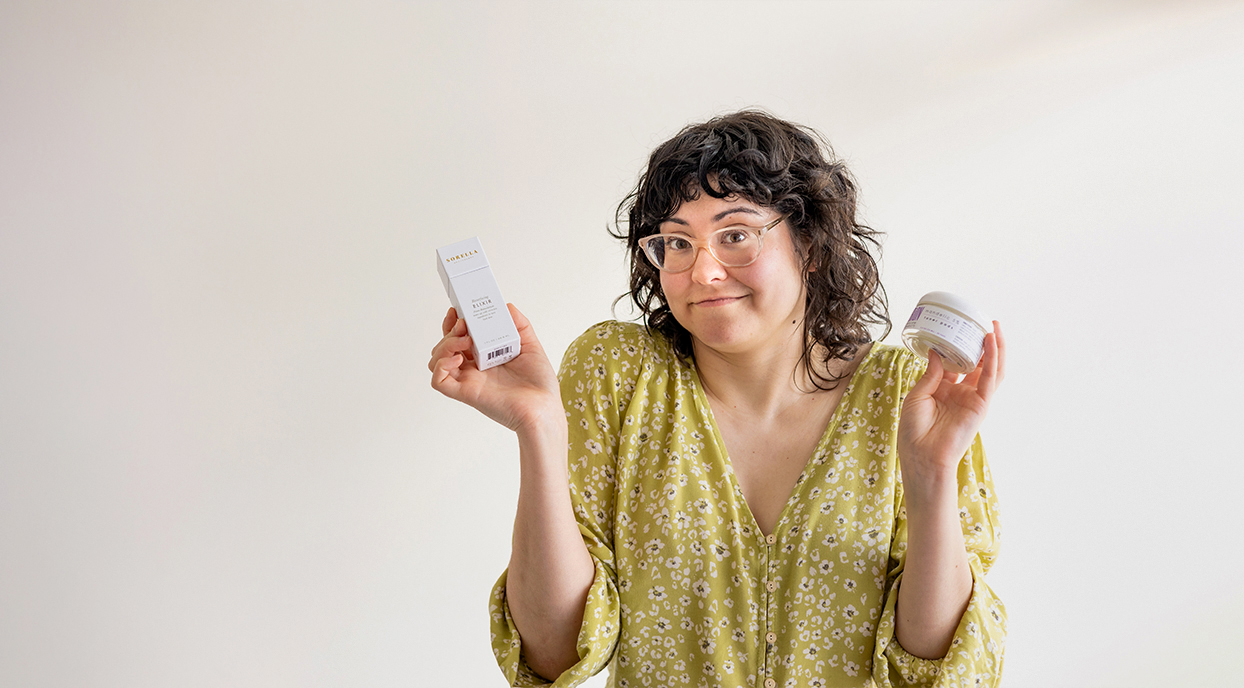 Girl questioning what skin cycling is all about. She is holding two skincare products to use while skin cycling